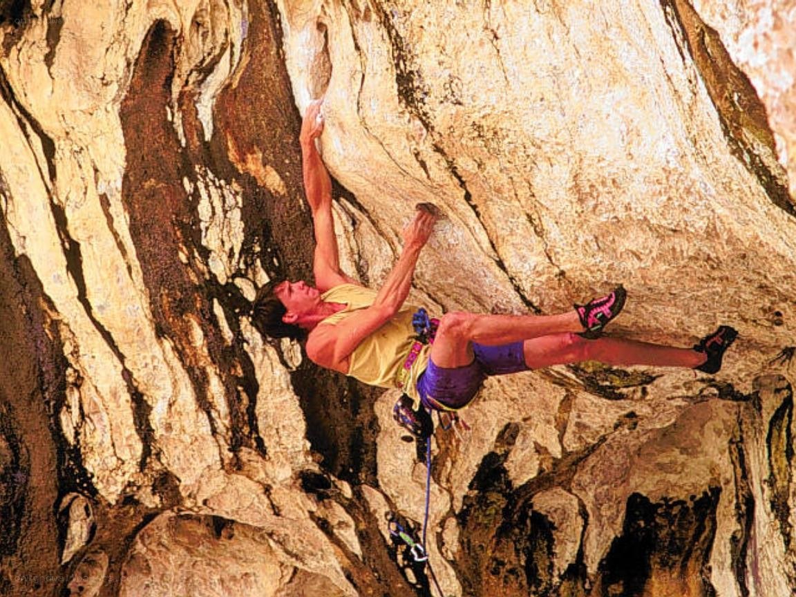 Climber scaling a rock face