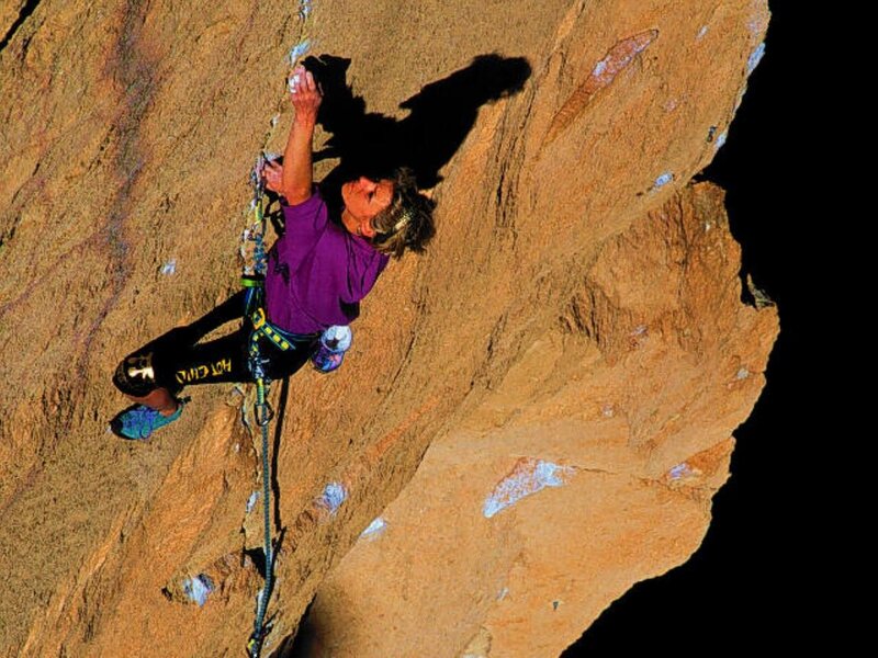 Climber scaling a rock face
