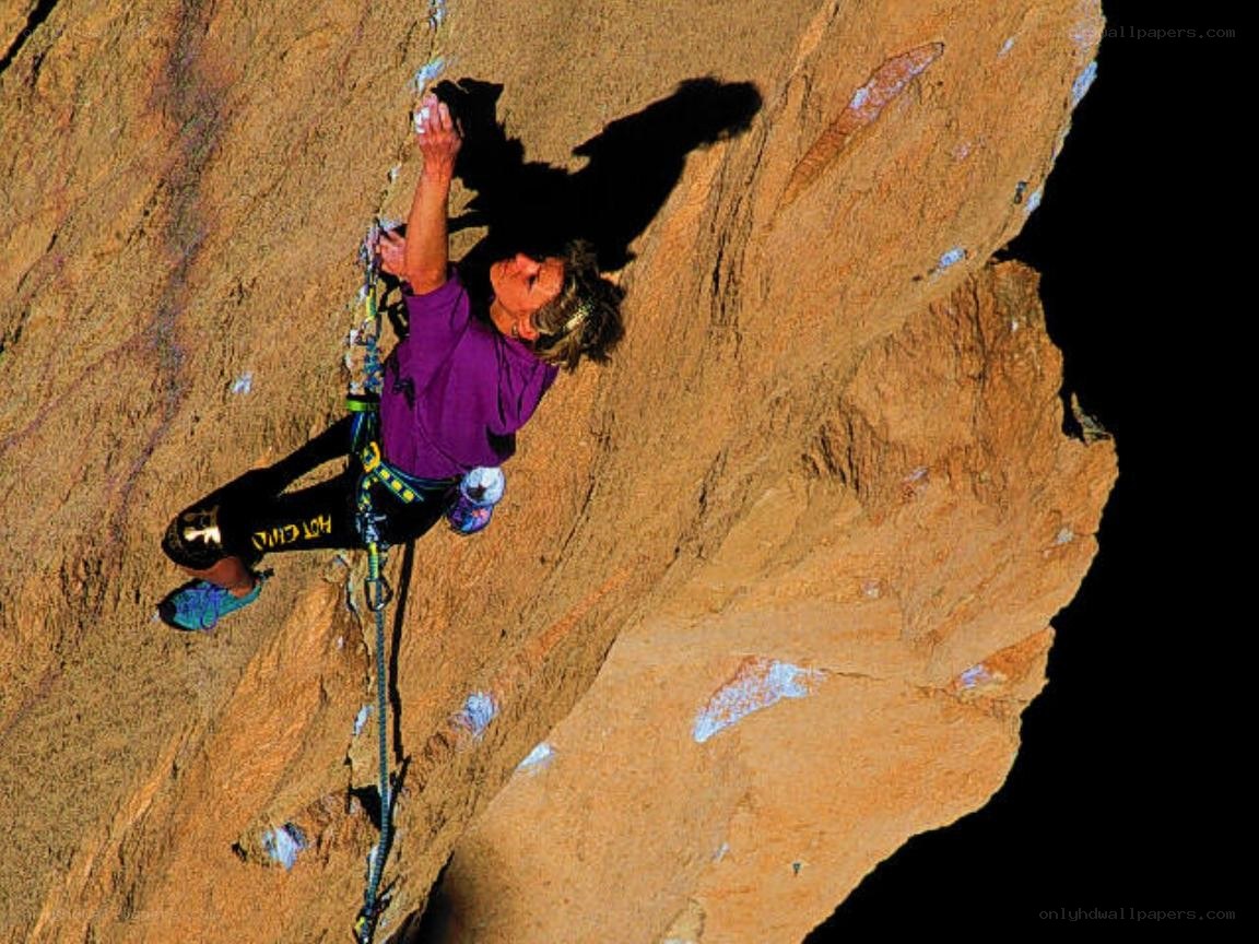 Climber scaling a rock face