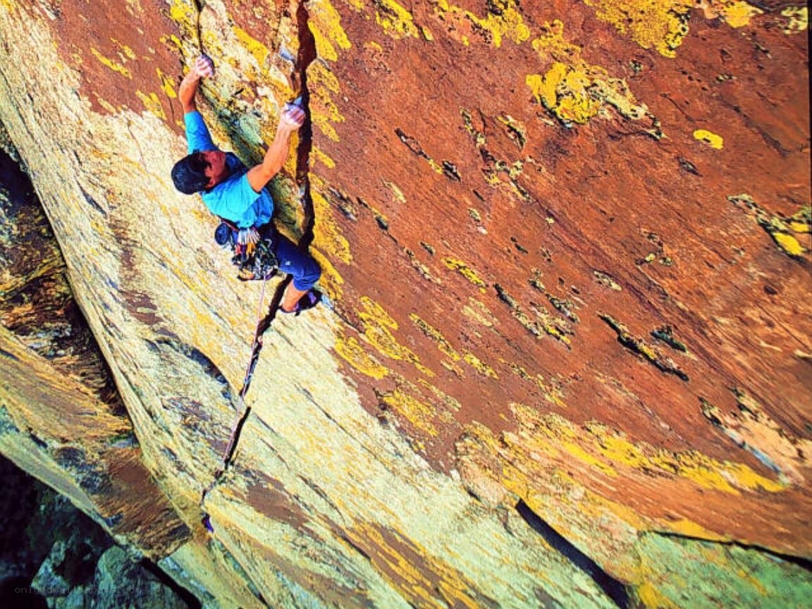 Climber scaling a rock face