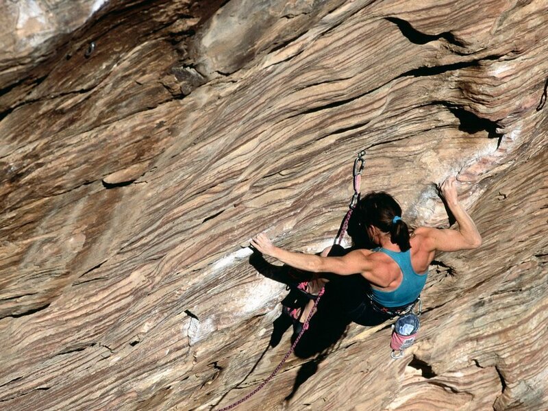 Climber scaling a rock face