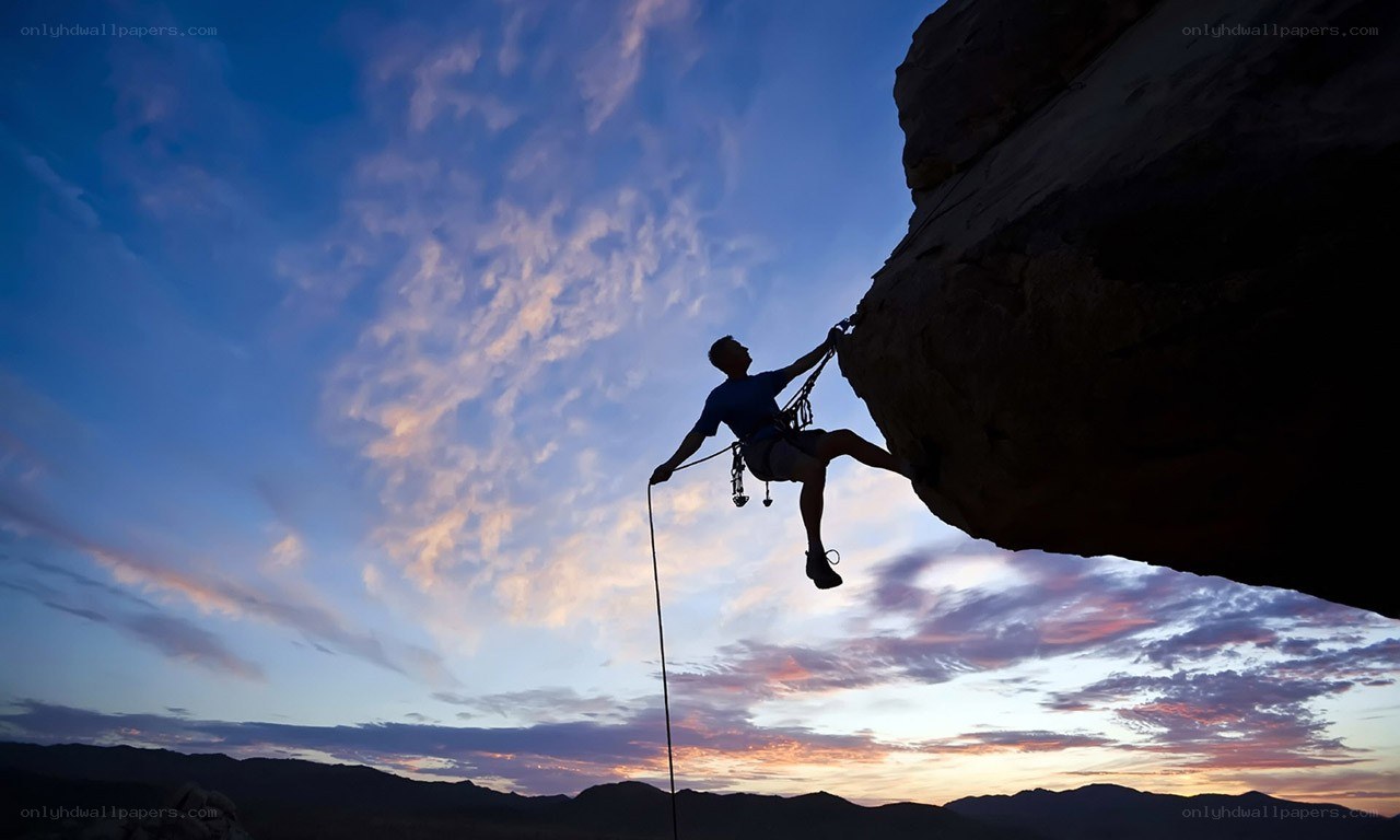 Climber silhouetted against sunset