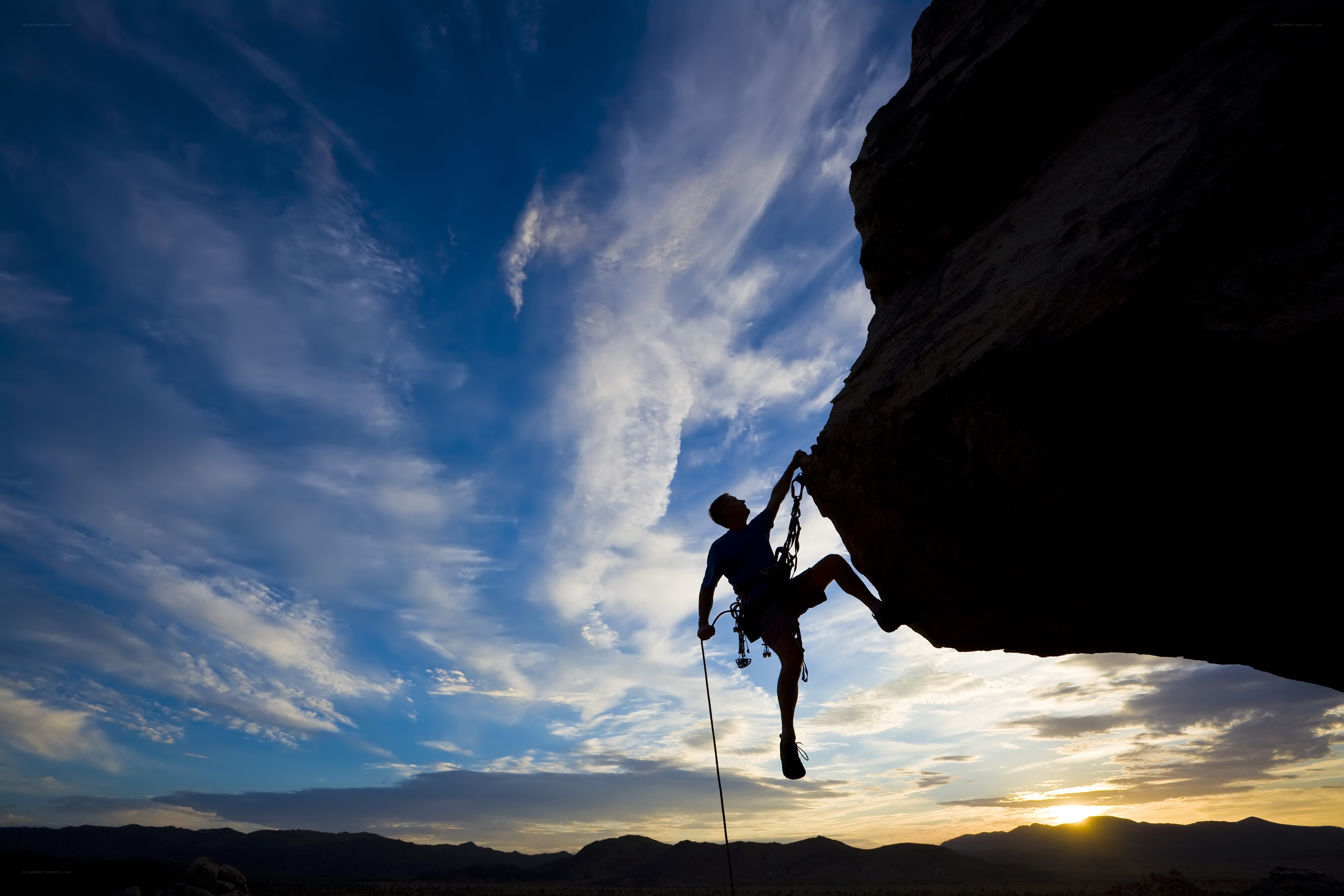 Climber silhouetted against sunset