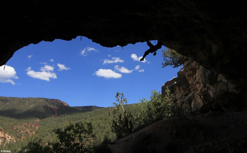 Climber silhouetted in cave
