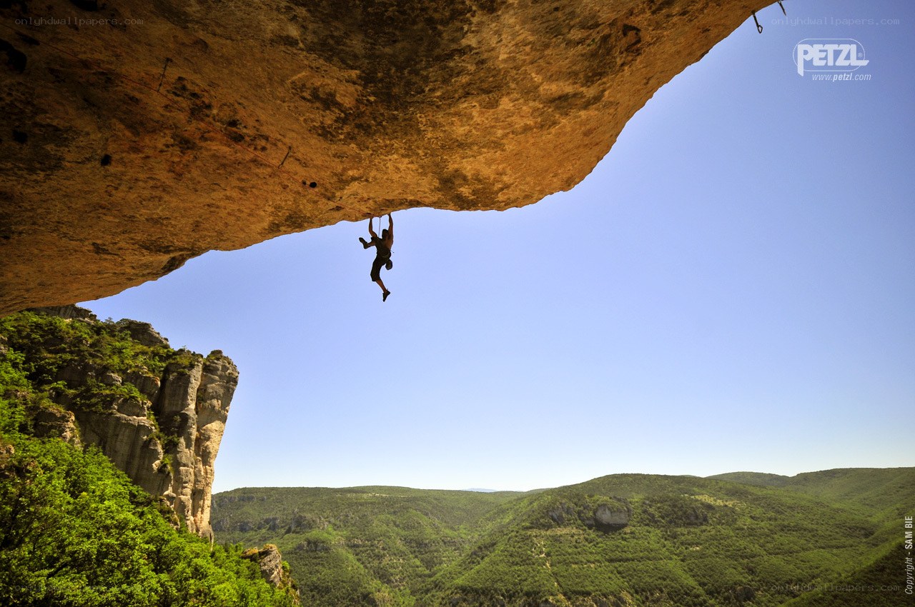 Climber under a rock overhang