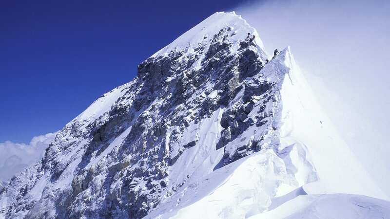 Climbers on a snowy mountain peak