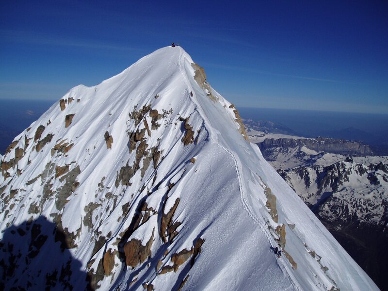 Climbers on a snowy mountain peak