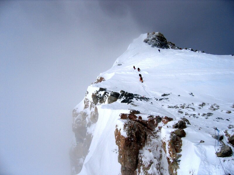 Climbers on a snowy mountain ridge