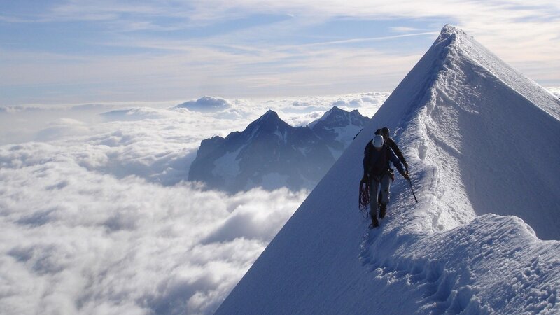 Climbers on a snowy mountain ridge