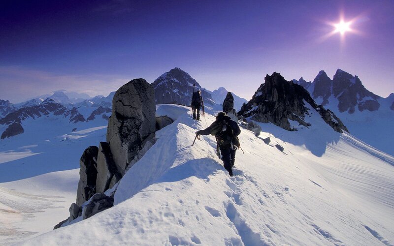 Climbers on a snowy mountain ridge