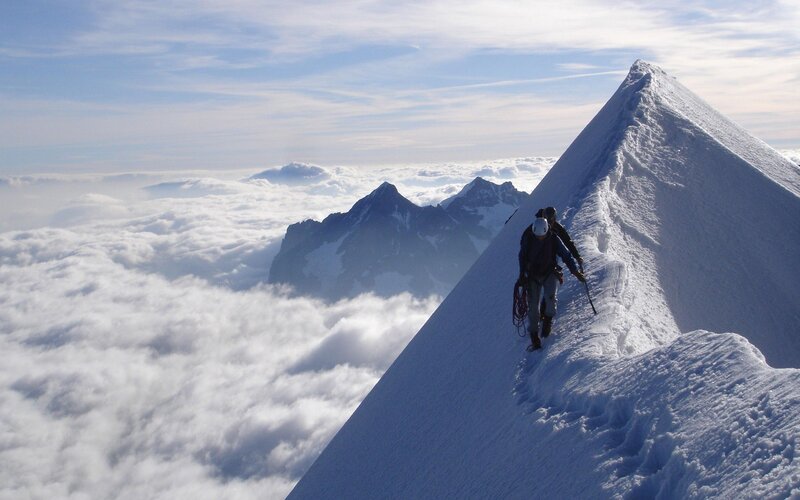 Climbers on a snowy mountain ridge