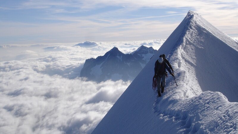 Climbers on a snowy mountain ridge