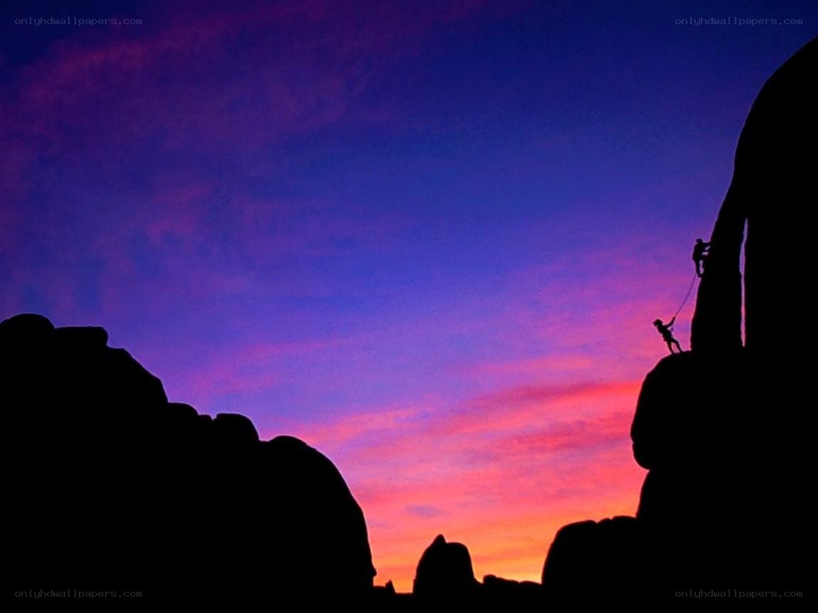 Climbers silhouetted against sunset