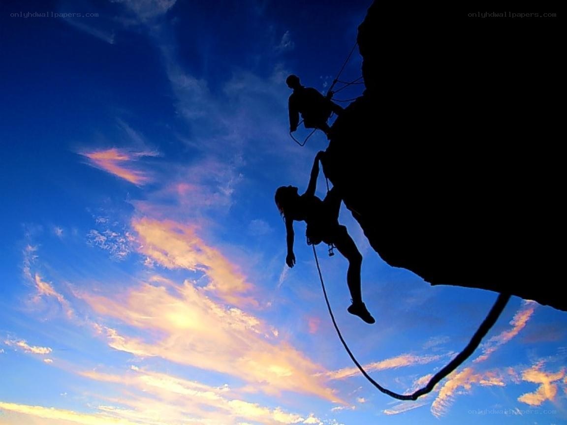 Climbers silhouetted against sunset
