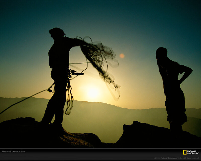 Climbers silhouetted at sunset