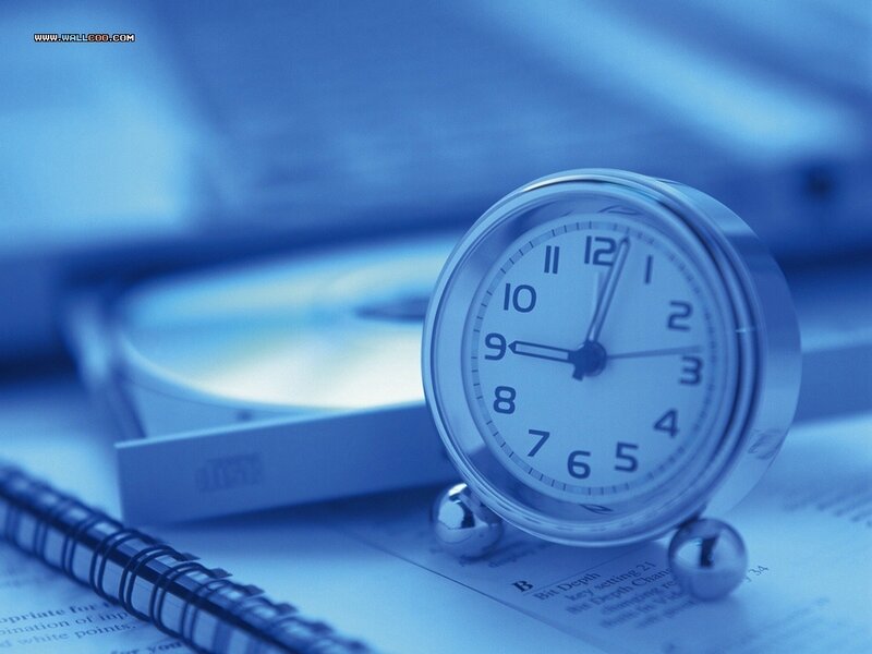Clock on a desk with documents