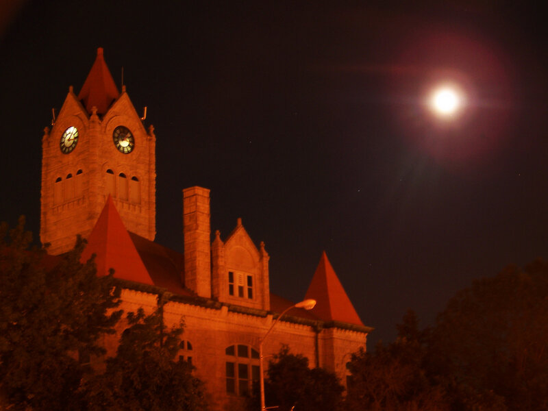 Clock tower at night with moon
