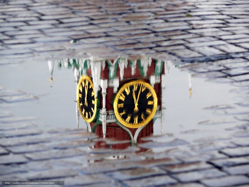 Clock tower reflection in puddle