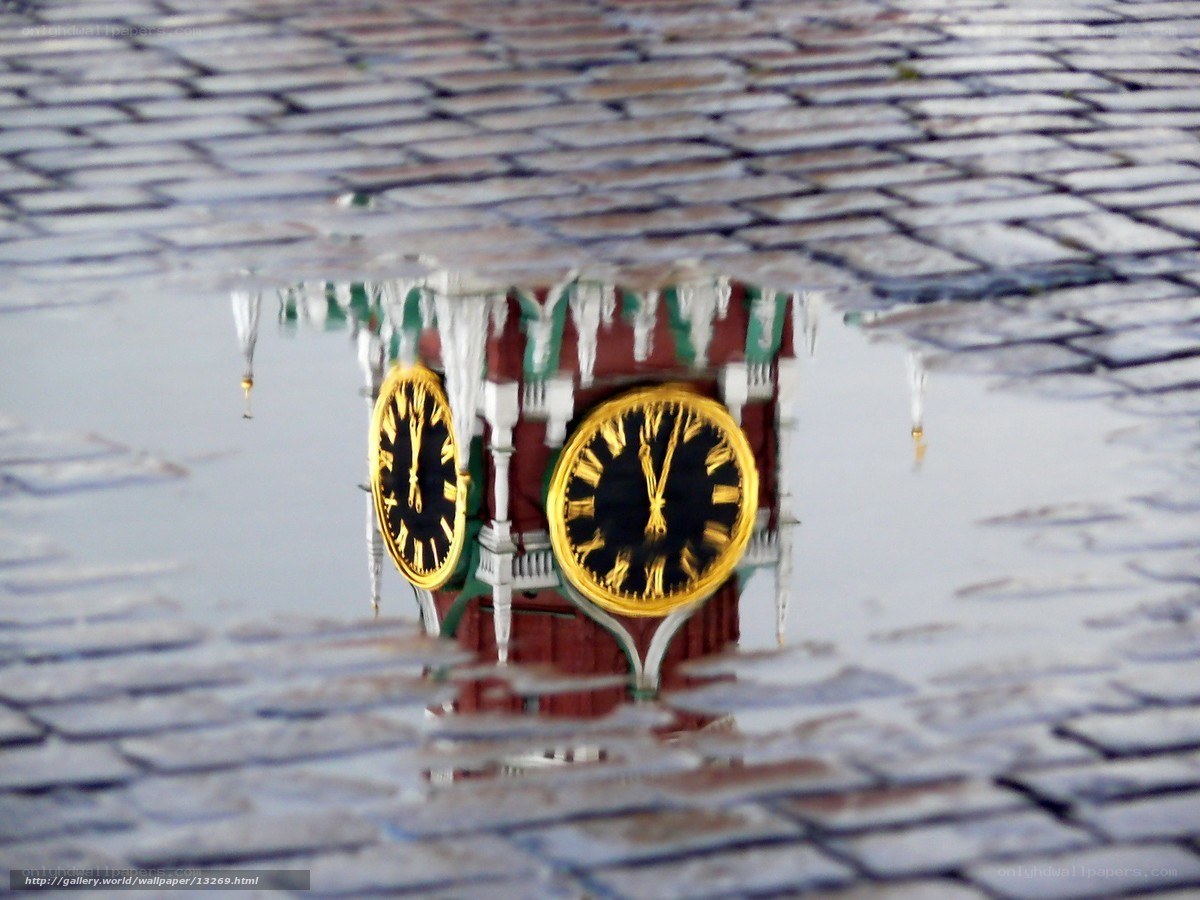 Clock tower reflection in puddle