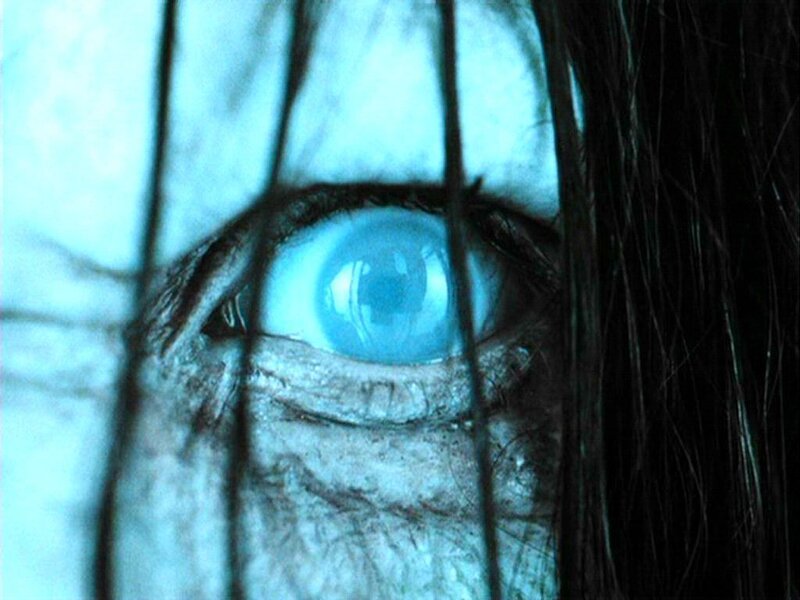 close-up of a blue eye behind bars