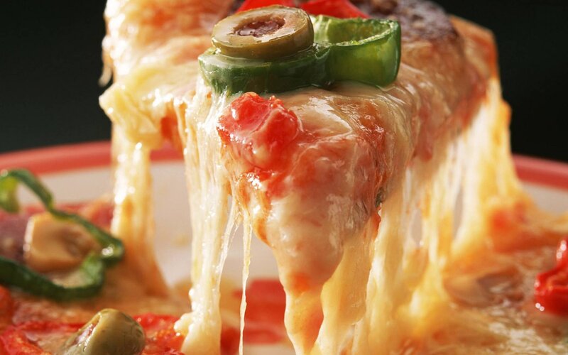 Close-up of a cheesy pizza slice