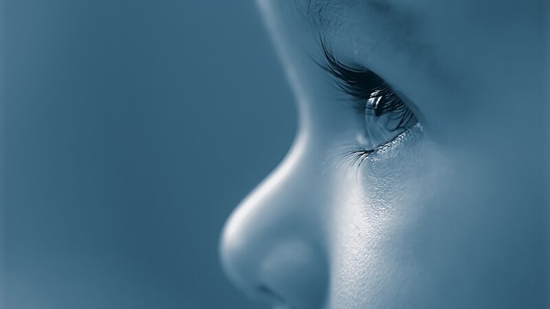Close-up of a Child's Face — Blue, Contemplative, Photograph