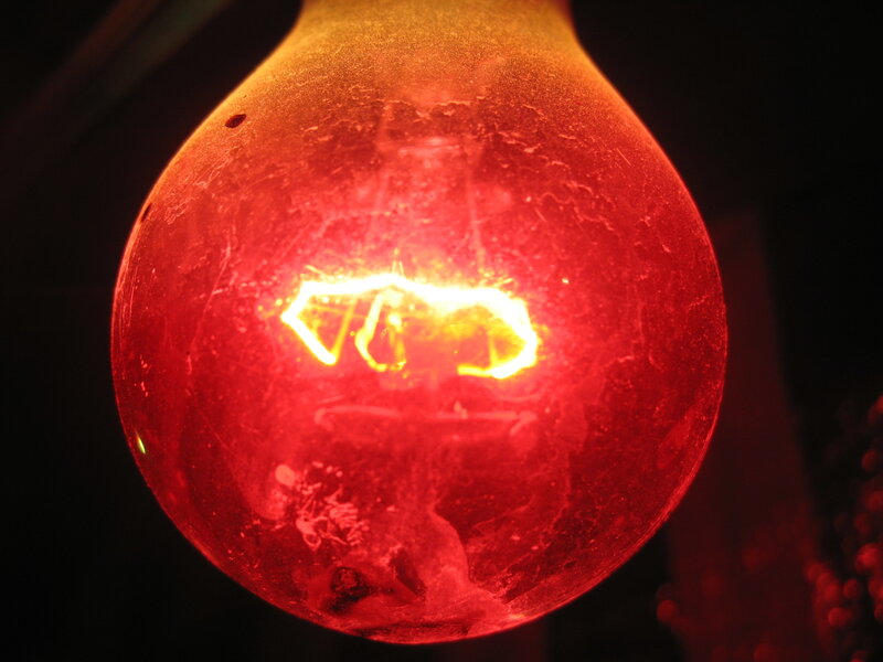 Close-up of a glowing red light bulb
