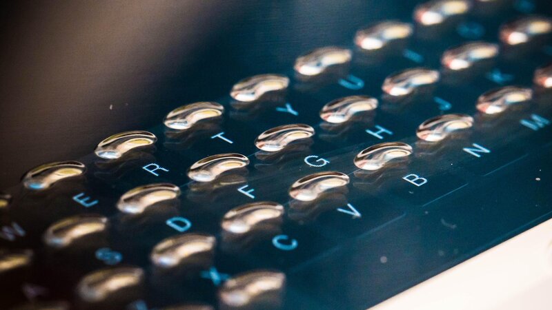Close-up of a keyboard with water droplets
