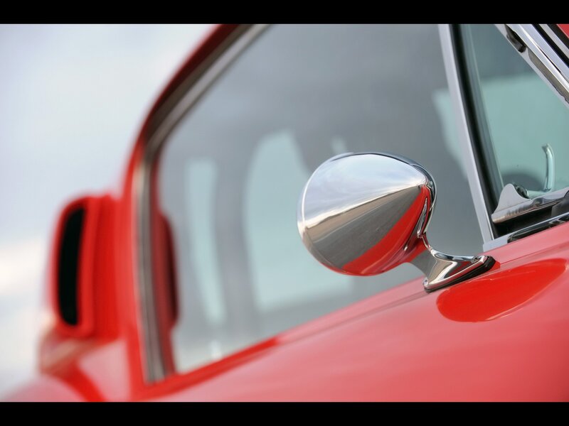 Close-up of a red car mirror