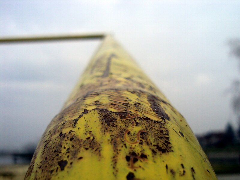 close-up of a rusty yellow pole