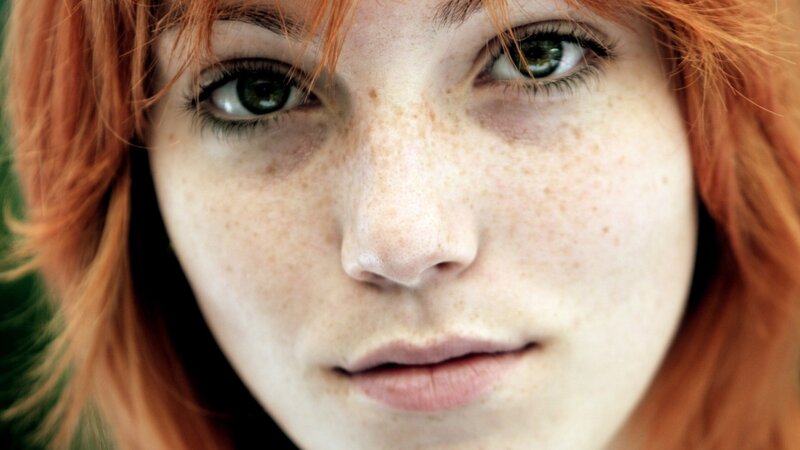 close-up of a young woman with freckles
