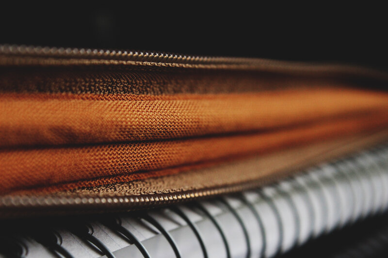 close-up of a zipper and notebook