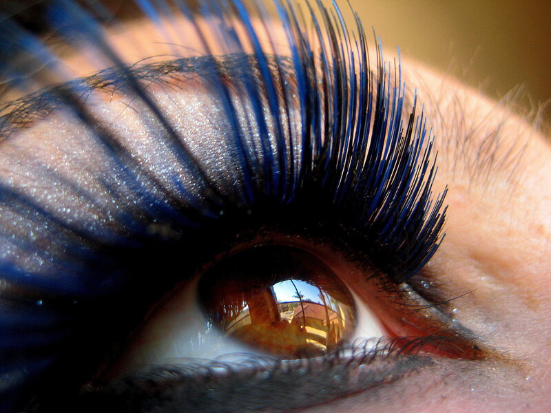 close-up of an eye with blue mascara