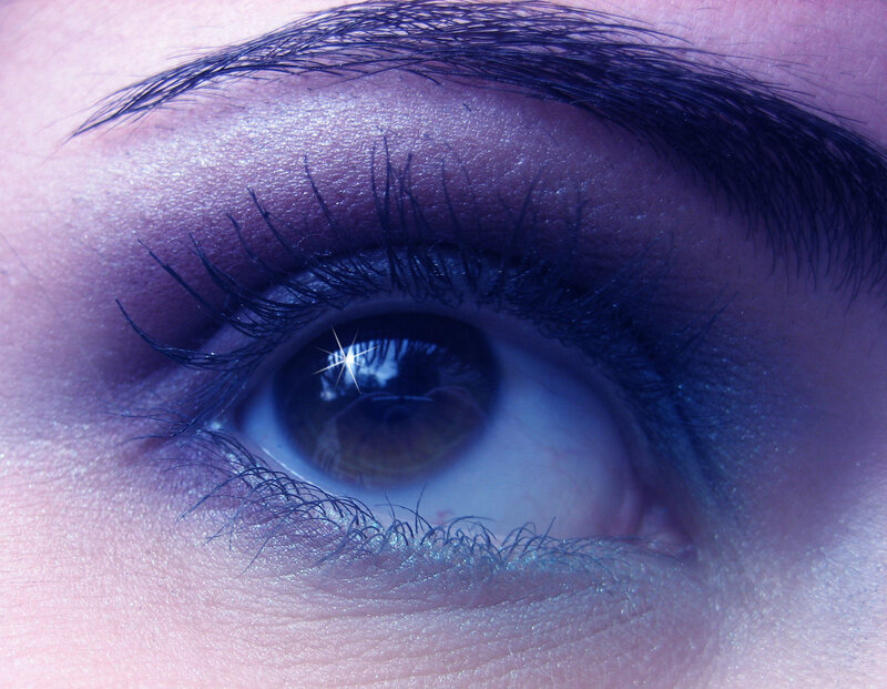 close-up of an eye with purple lighting
