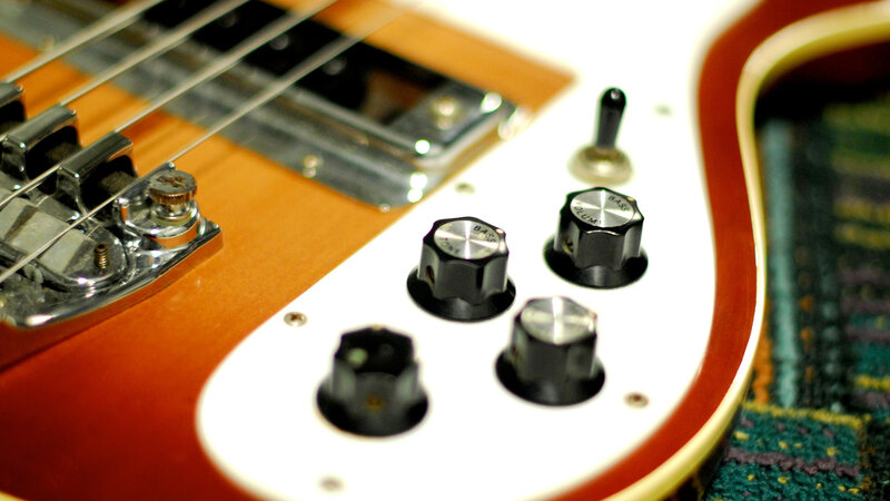 close-up of bass guitar controls