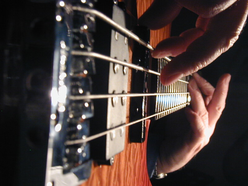 close-up of bass guitar playing