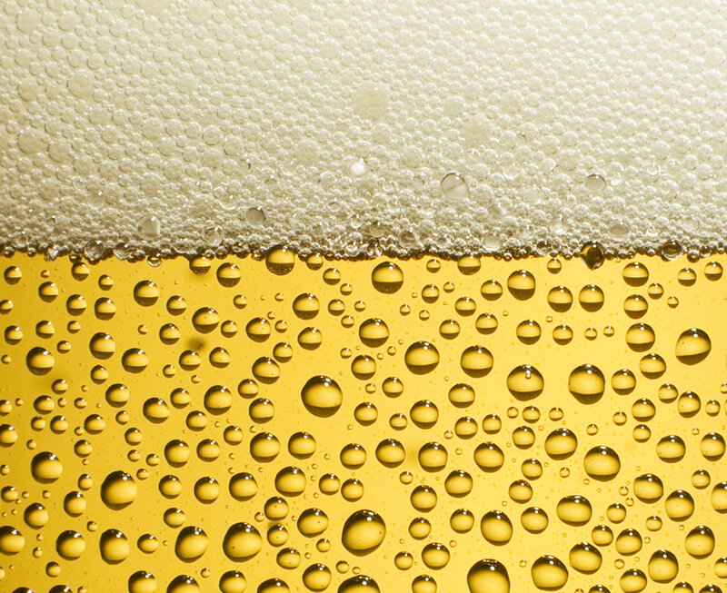 Close-up of beer foam and bubbles