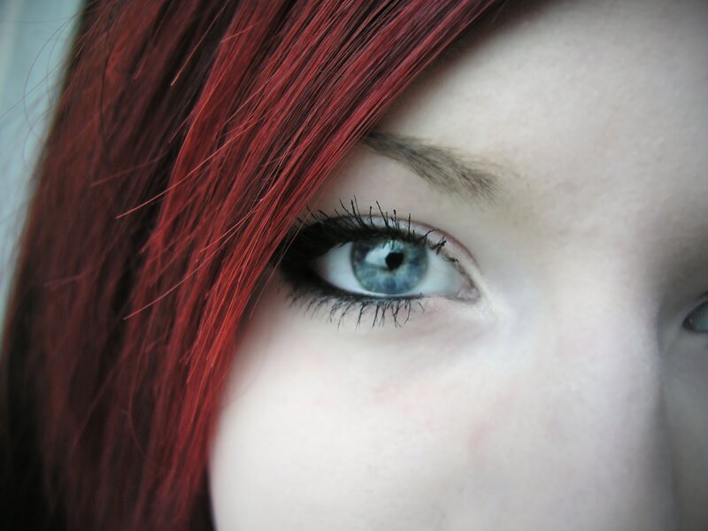 close-up of blue eye and red hair