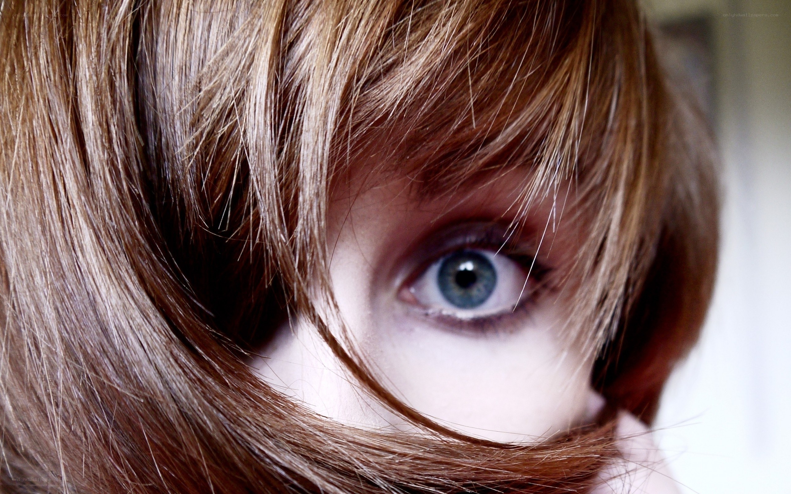 close-up of blue eye with hair