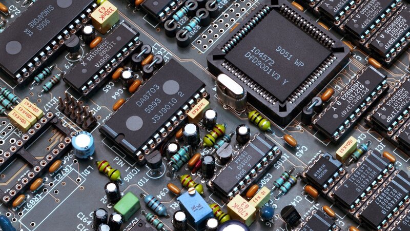Close-up of Circuit Board — Black, Technical, Photograph, Microchips, Resistors, Capacitors, Green, Blue