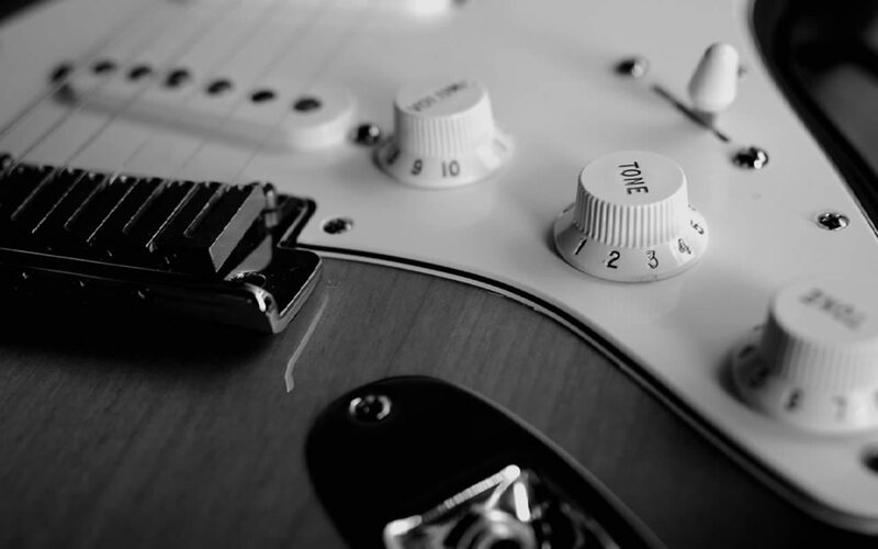 close-up of electric guitar controls