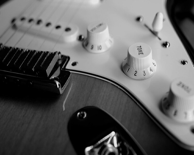 close-up of electric guitar controls