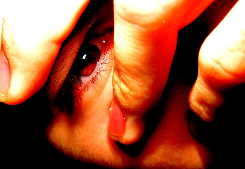 close-up of eye with fingers