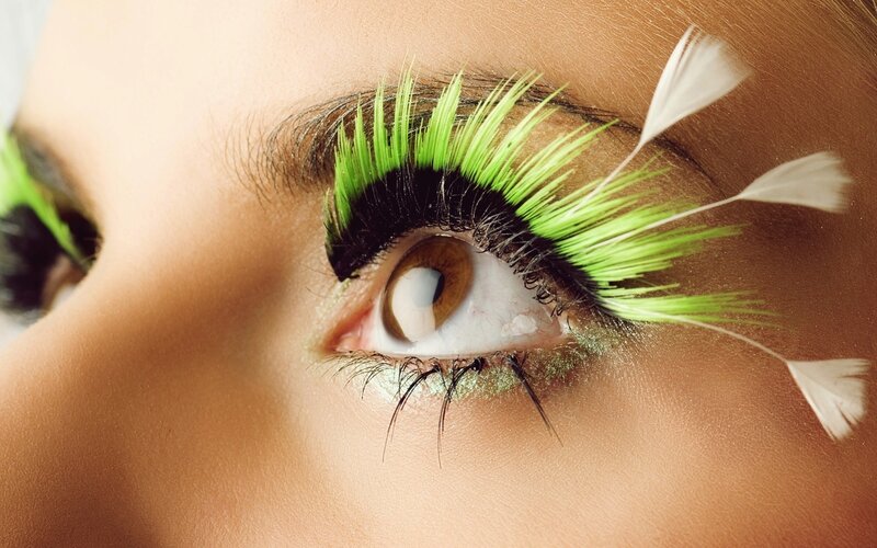 close-up of eye with green lashes