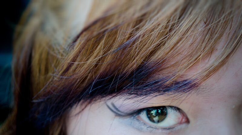 close-up of eye with hair