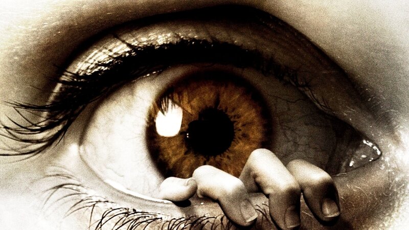 Close-up of eye with hand