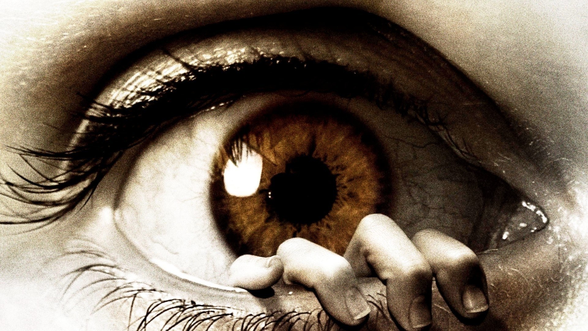 Close-up of eye with hand