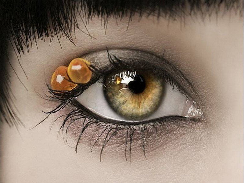 close-up of eye with orange beads