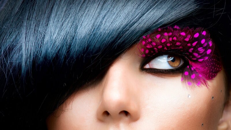 close-up of eye with pink feathers