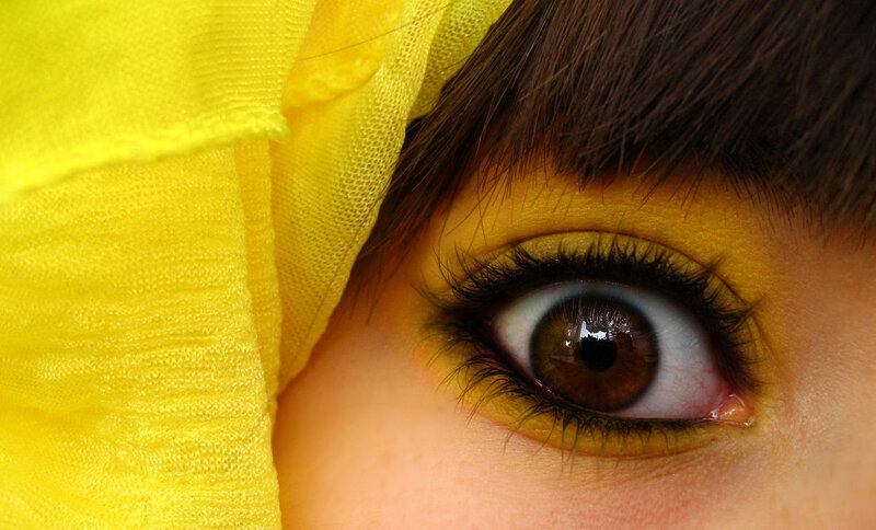 close-up of eye with yellow makeup